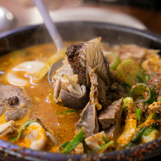 Hot pot dish with various ingredients in a pot on a table